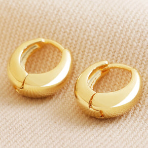 Domed huggie hoop earrings in gold